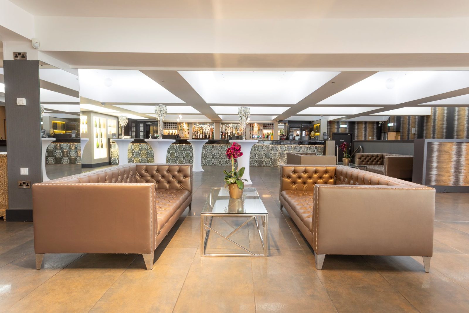 Elegant lounge area with brown sofas and modern decor