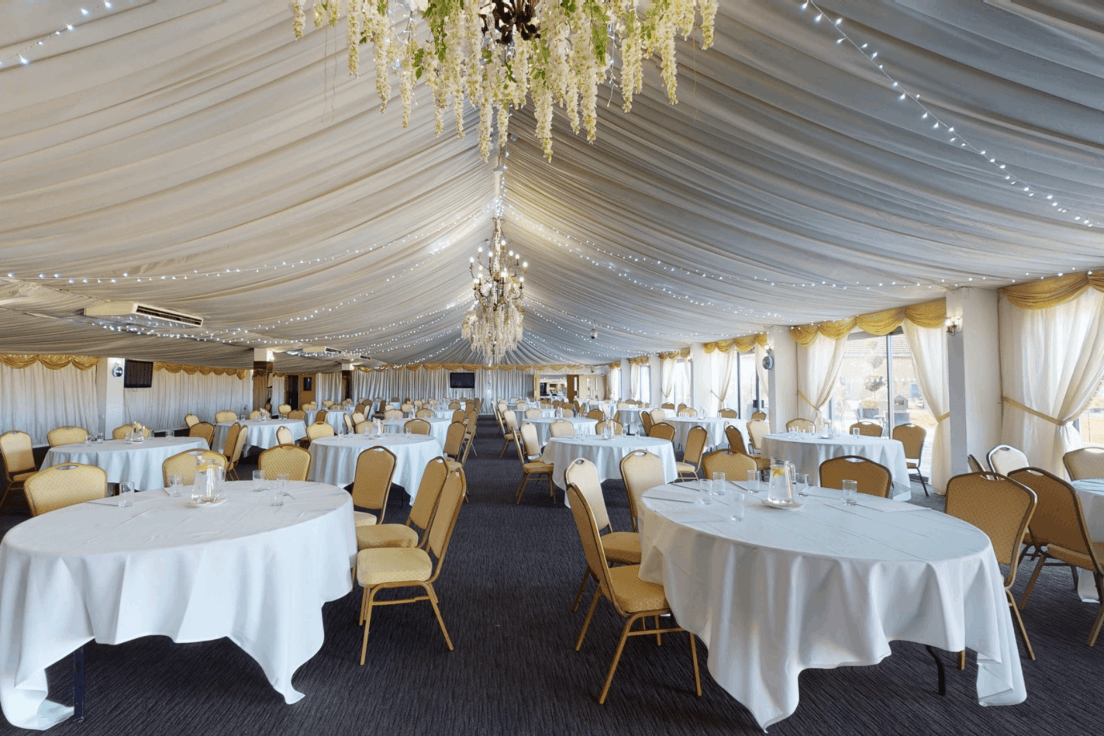 Elegant event space with round tables and festive decor