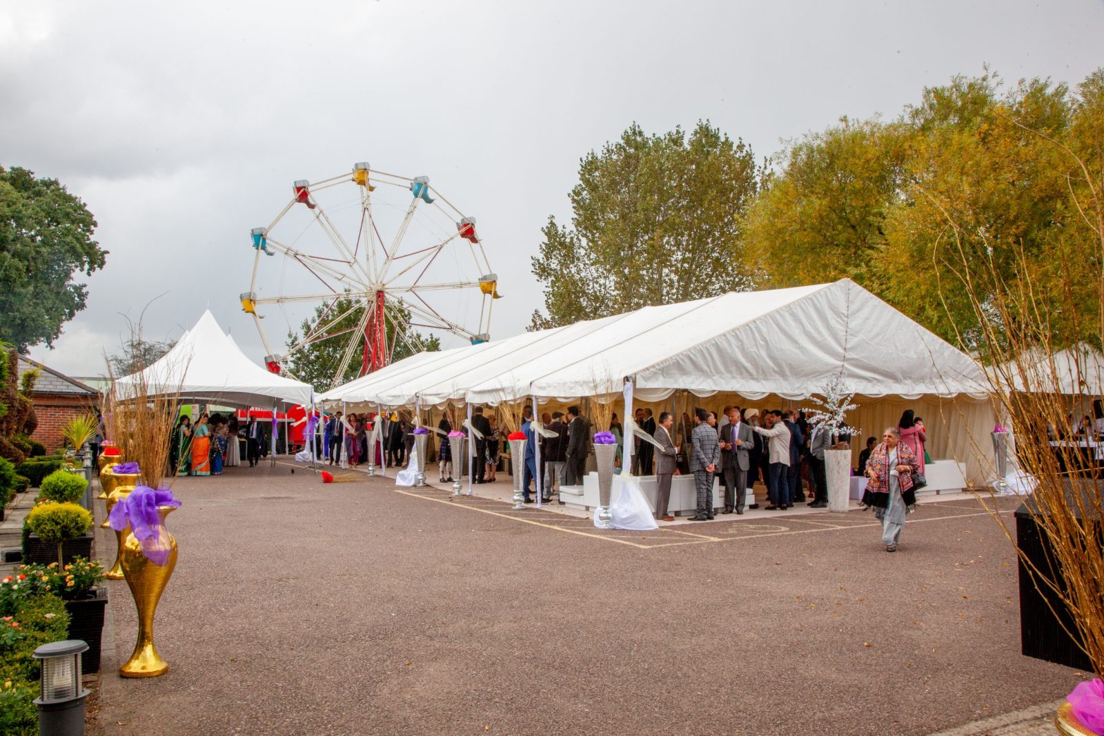Outdoor event with tents and ferris wheel