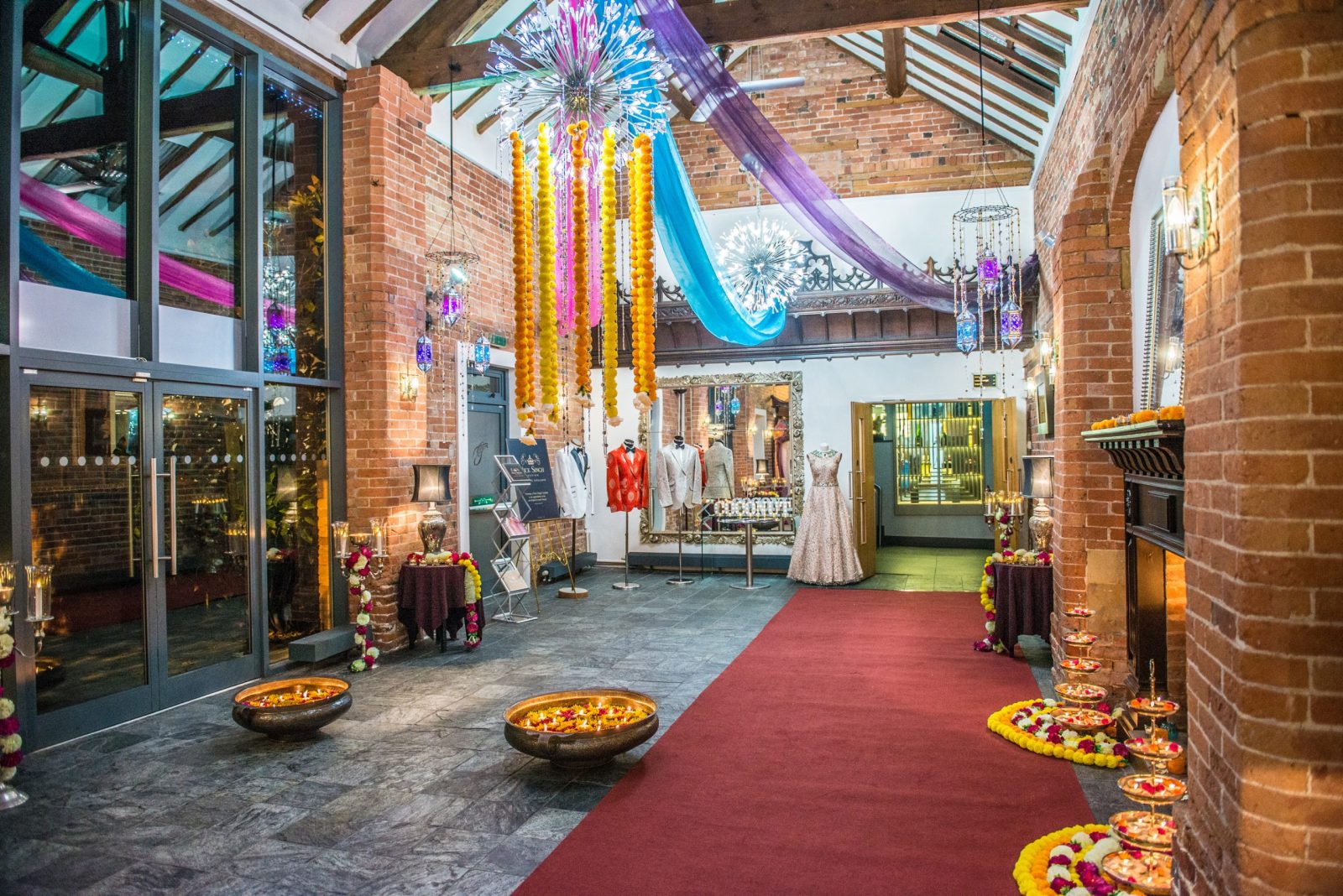 Decorated event entrance with vibrant colors and floral arrangements