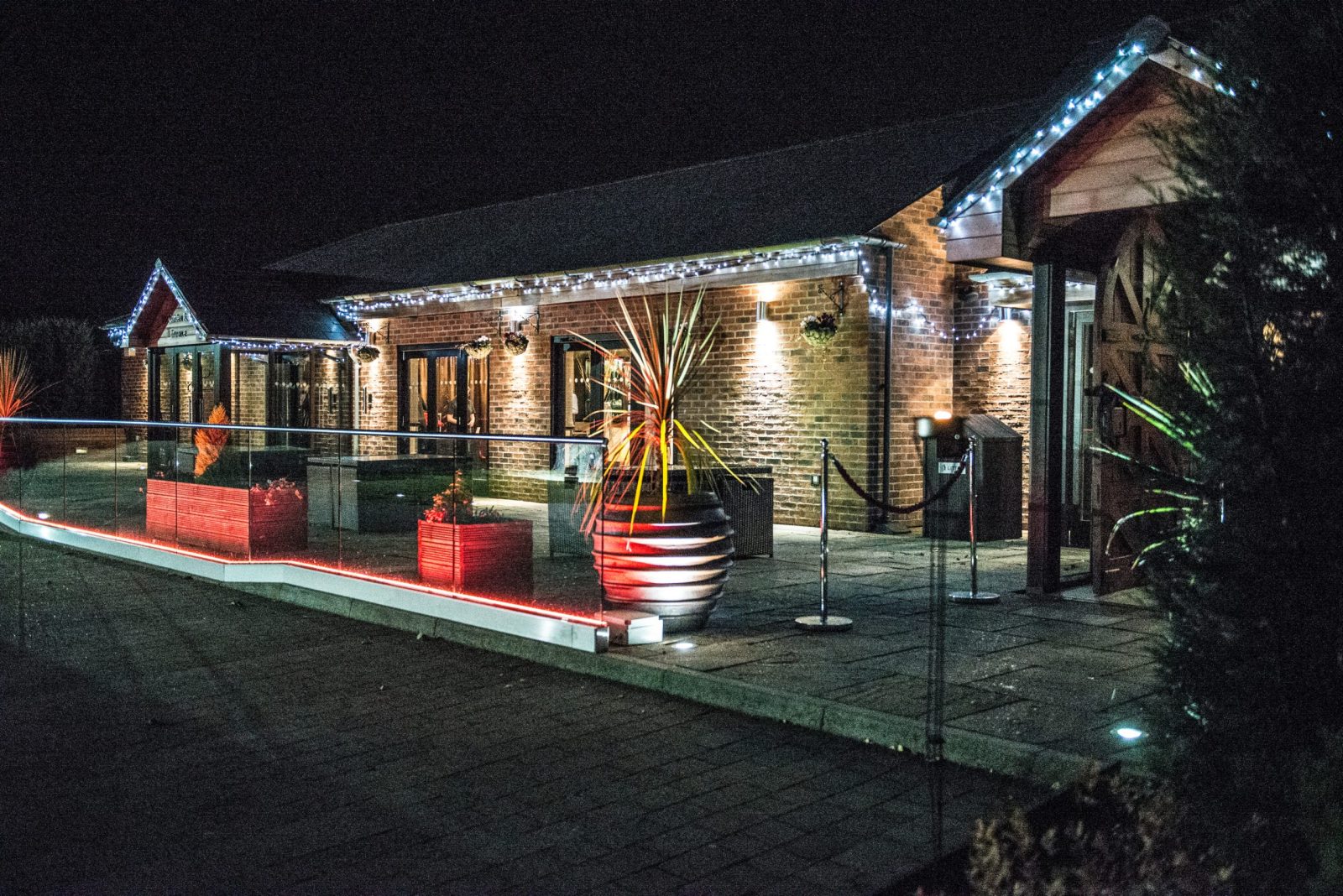 Nighttime view of a beautifully lit building with outdoor decor