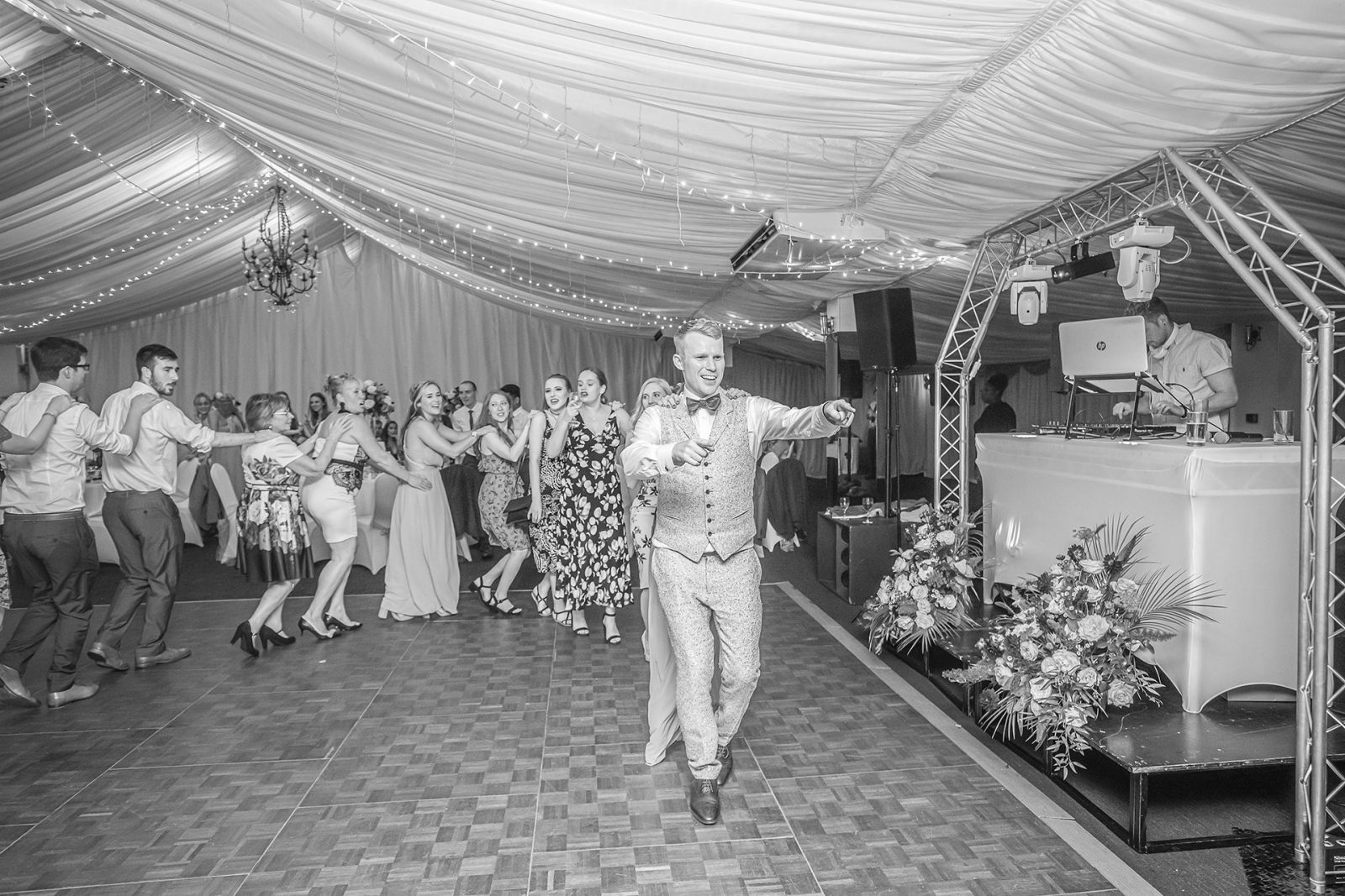 Bride and guests dancing at wedding reception